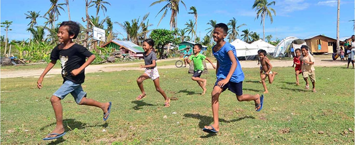 Children running through a field
