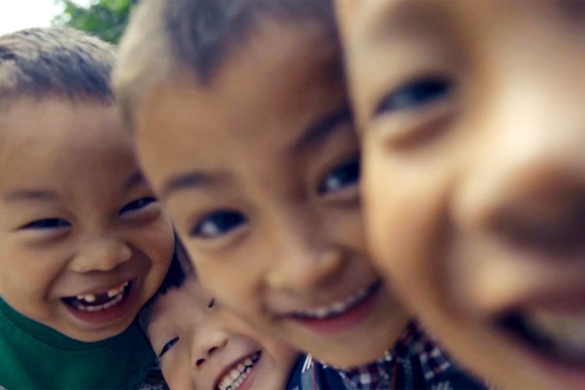 Group of children smiling into the camera
