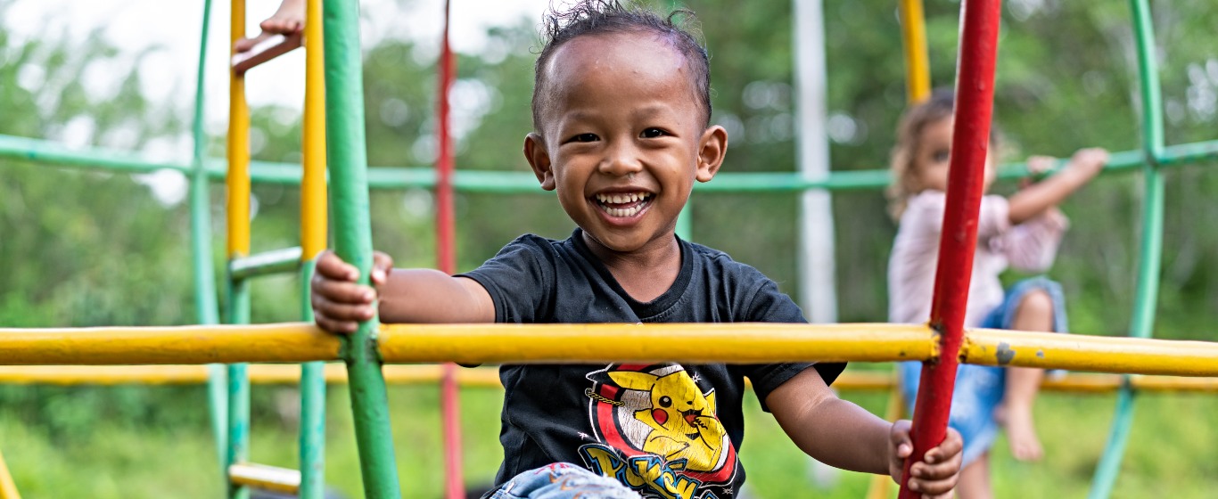 Young child in playground with friend