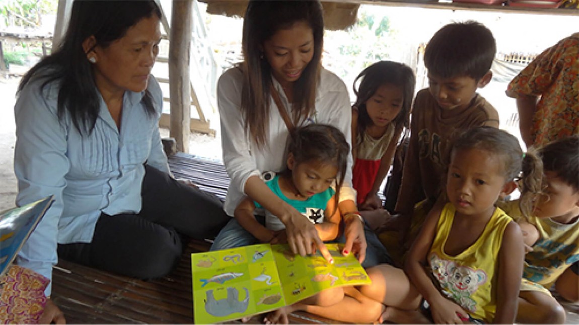 Parents teaching literacy skills to children