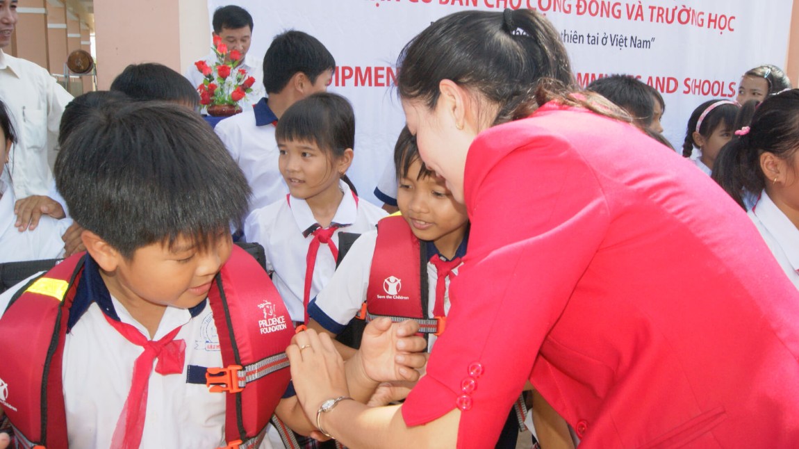 Children learning how to use lifejackets
