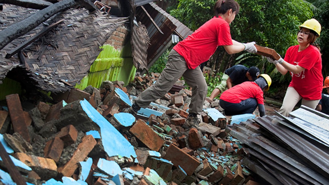 Volunteers moving rubble.